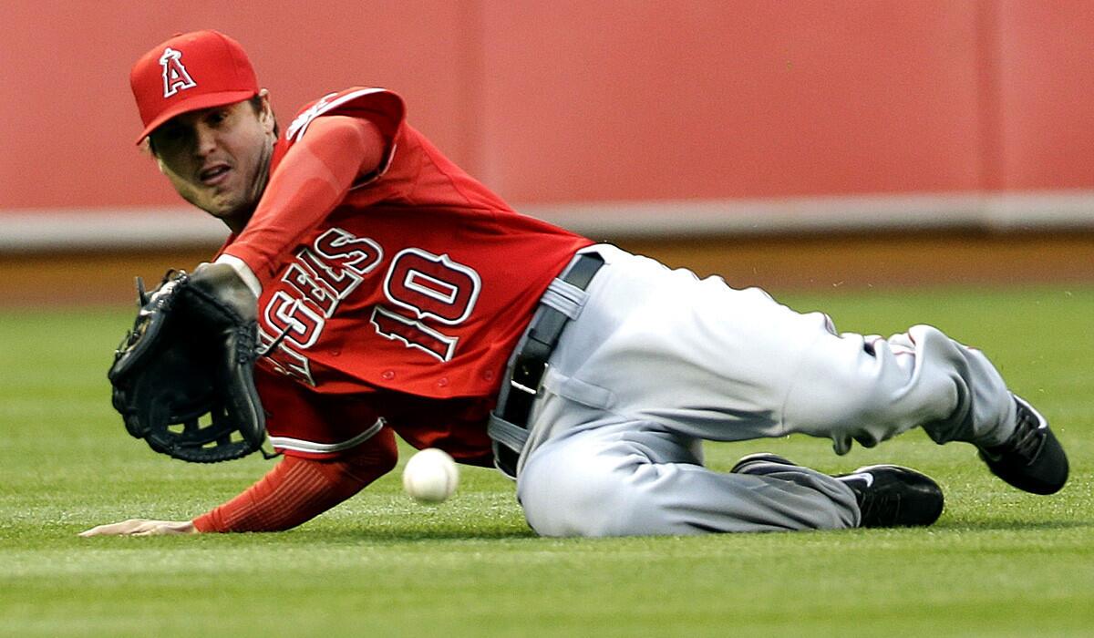 Angels left fielder Grant Green can't make a sliding catch on a line drive hit by Oakland's Jed Lowrie in the first inning Friday night in Oakland.