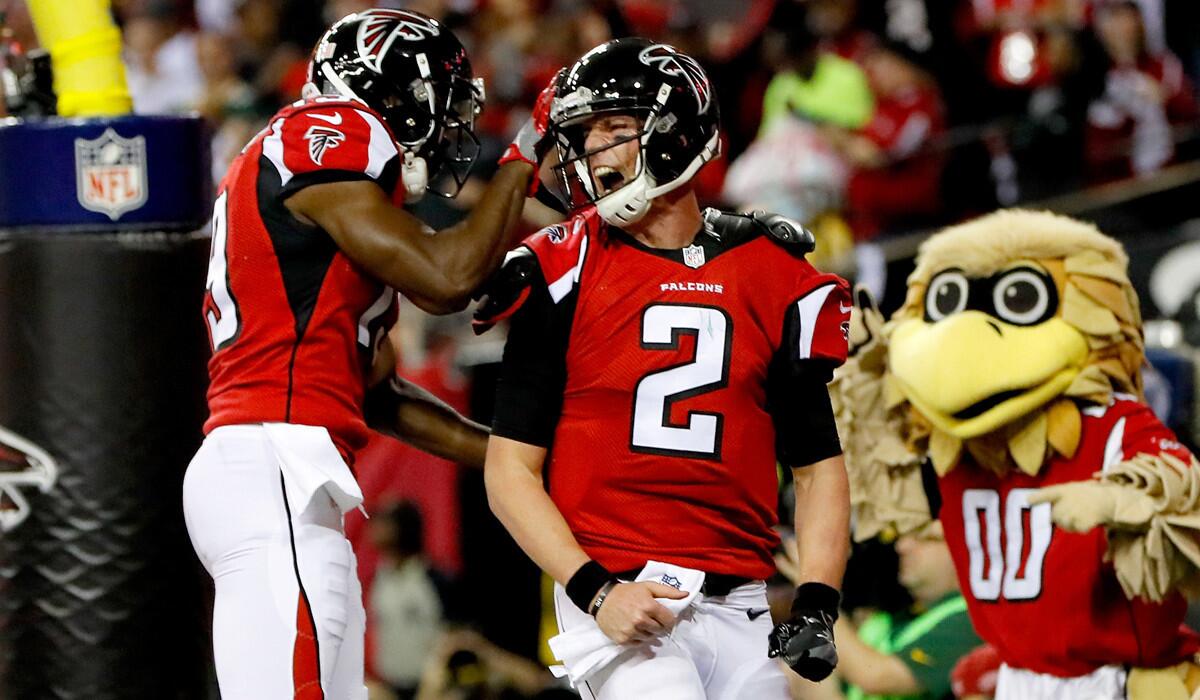 Atlanta Falcons quarterback Matt Ryan (2) celebrates with teammate Aldrick Robinson after a touchdown against the Green Bay Packers in the NFC championship game Sunday.