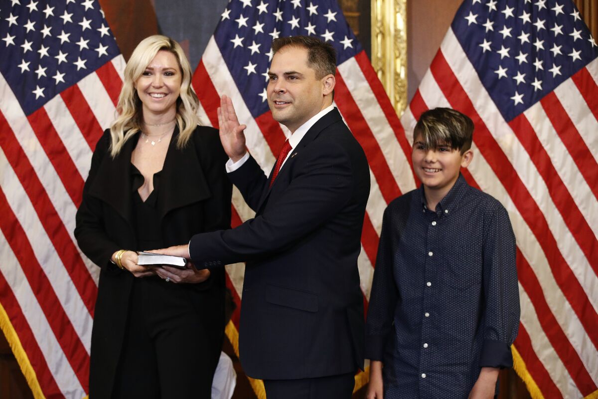 FILE - Rep. Mike Garcia, R-Calif., center, joined by his wife Rebecca, and son Preston, participates in a ceremonial swearing-in on Capitol Hill in Washington on May 19, 2020. A special election is being held in California's farm belt to complete the term of former Rep. Devin Nunes, who resigned to join ex-President Donald Trump's media company. The April 5, 2022 contest in the Republican-leaning 22nd District is being largely overlooked as national Republicans and Democrats focus on midterm elections that will determine control of Congress in 2023. (AP Photo/Patrick Semansky, File)