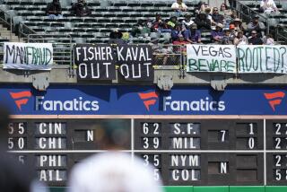 Signs hang in right field at RingCentral Coliseum during a baseball game between the Oakland Athletics and the Houston Astros in Oakland, Calif., Saturday, May 27, 2023. (AP Photo/Jeff Chiu)