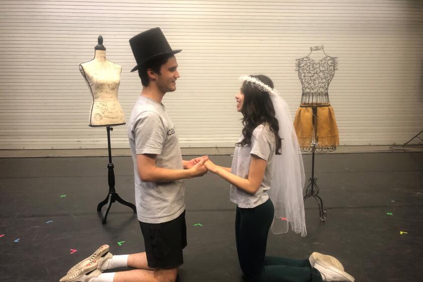 Mason Ballard as Tony, left, and Ina Lelevier as Maria rehearse a scene for Teatro San Diego's "West Side Story," opening Aug. 18 in City Heights.