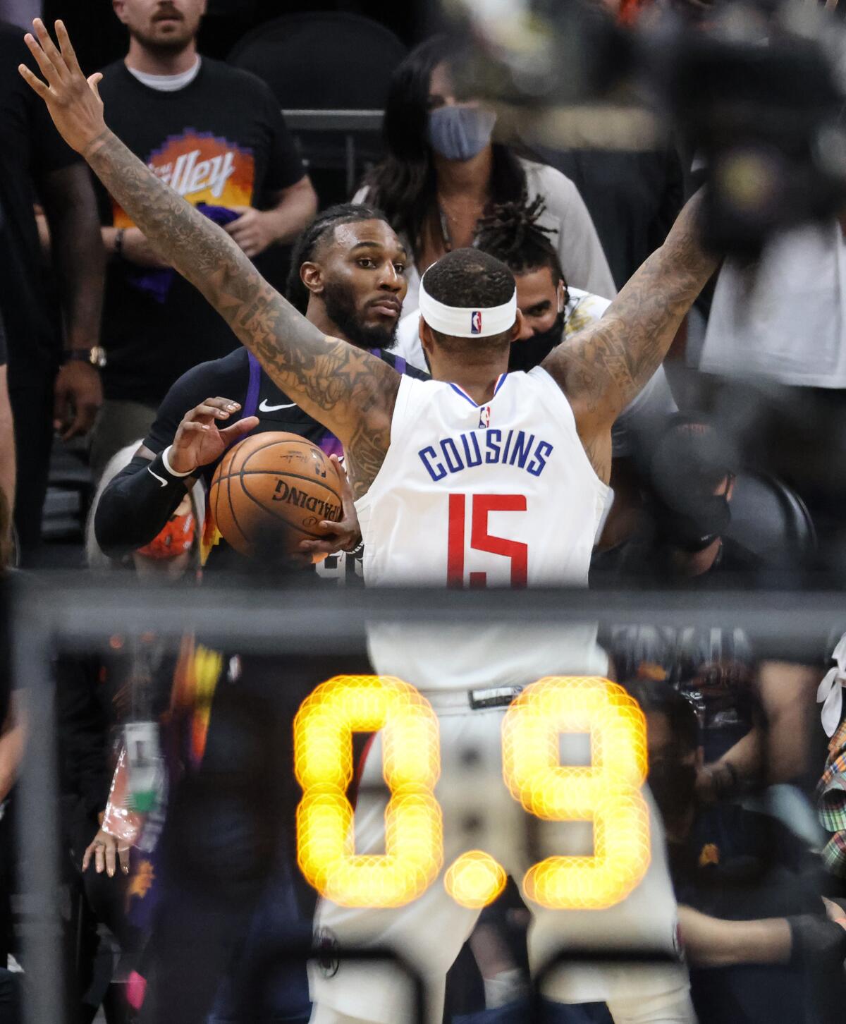 Phoenix Suns forward Jae Crowder surveys the court as Clippers center DeMarcus Cousins covers him with 0.9 seconds remaining.