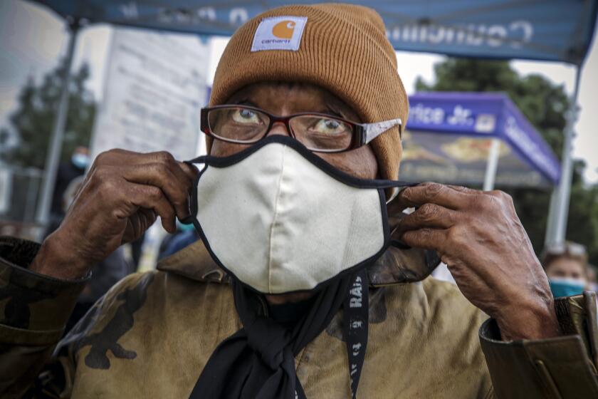Los Angeles, CA - February 09: Lawrence Taylor, 77, waits for his turn to get COVID-19 vaccine at a mobile vaccination site launched by Los Angeles Councilman Curren Price Jr. at South Park Recreation Center on Tuesday, Feb. 9, 2021 in Los Angeles, CA.(Irfan Khan / Los Angeles Times)