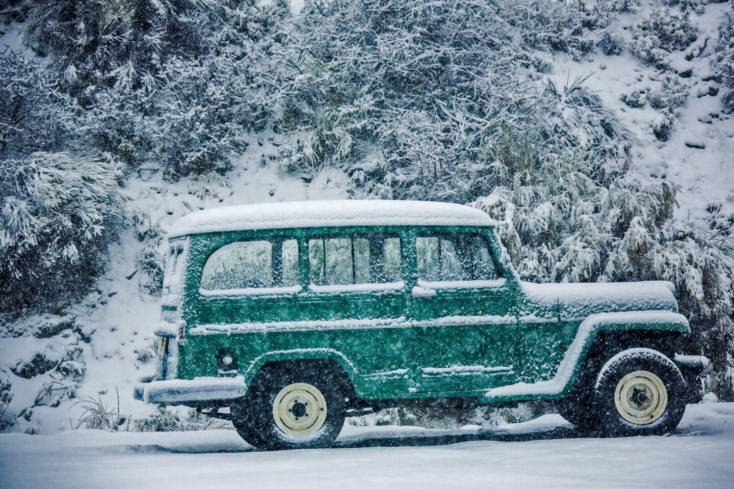 Heavy snow fall blankets an old truck in Wrightwood.