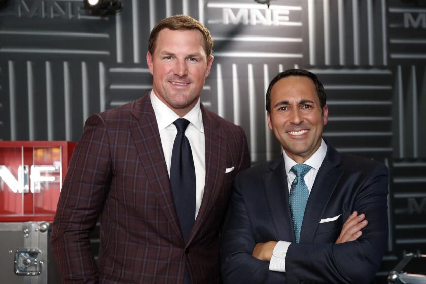 Former NFL player and no analyst Jason Witten, left, and play-by-play commentator Joe Tessitore pose for a photograph before their ESPN telecast of a preseason NFL football game between the Washington Redskins and the New York Jets, Thursday, Aug. 16, 2018, in Landover, Md. (AP Photo/Alex Brandon)