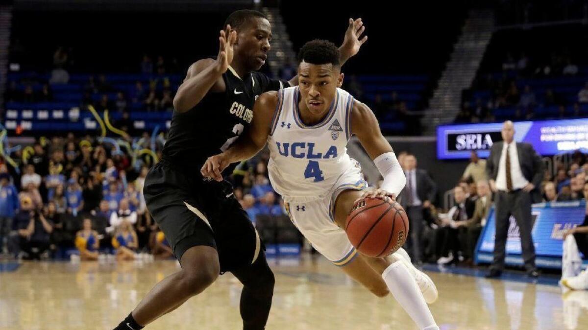UCLA guard Jaylen Hands, right, dribbles next to Colorado guard McKinley Wright IV during the second half of Wednesday's loss.