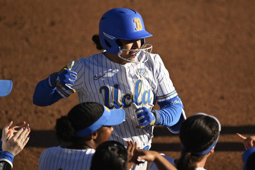 UCLA's Sharlize Palacios crosses home plate after hitting a homer against Stanford 