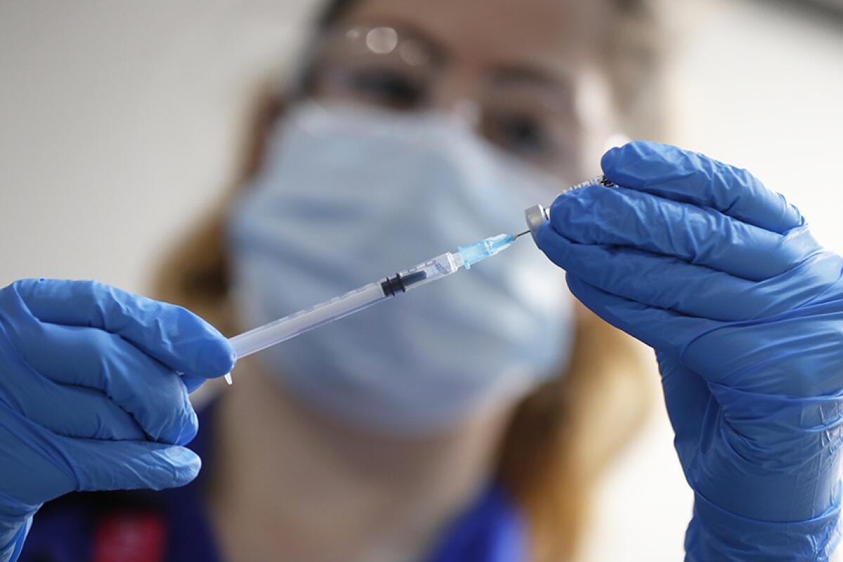 A nurse prepares a shot of the Pfizer-BioNTech COVID-19 vaccine in London.