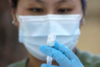 Pharmacist Ngoc-Chau Tran fills syringes with monkeypox vaccine at a  walk-up vaccination site at Barnsdall Art Park 