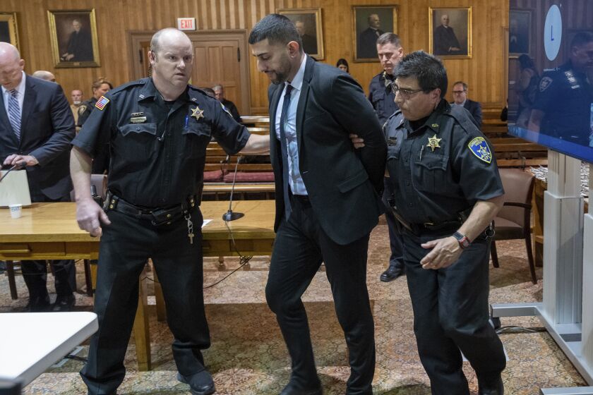 Nauman Hussain is taken into custody after he was found guilty in his trial, Wednesday, May 17, 2023, at Schoharie County Court in Schoharie, N.Y. Hussain, a limousine service manager, was convicted of manslaughter Wednesday in a crash that killed 20 people in rural New York, one of the deadliest U.S. road wrecks in two decades. (Jim Franco/The Albany Times Union via AP)