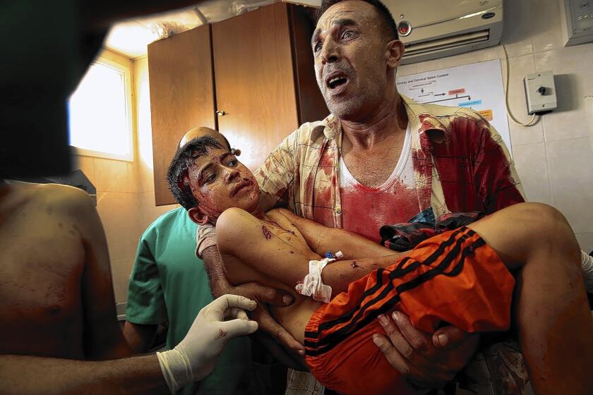 Victims of an explosion in downtown Gaza City are rushed to Shifa hospital. Children were among the dead.