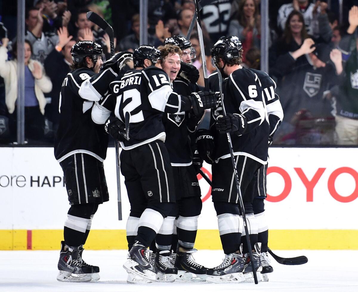 Kings forward Marian Gaborik (12) celebrates with his teammates after scoring a late third-period goal to tie the game at 3-3.