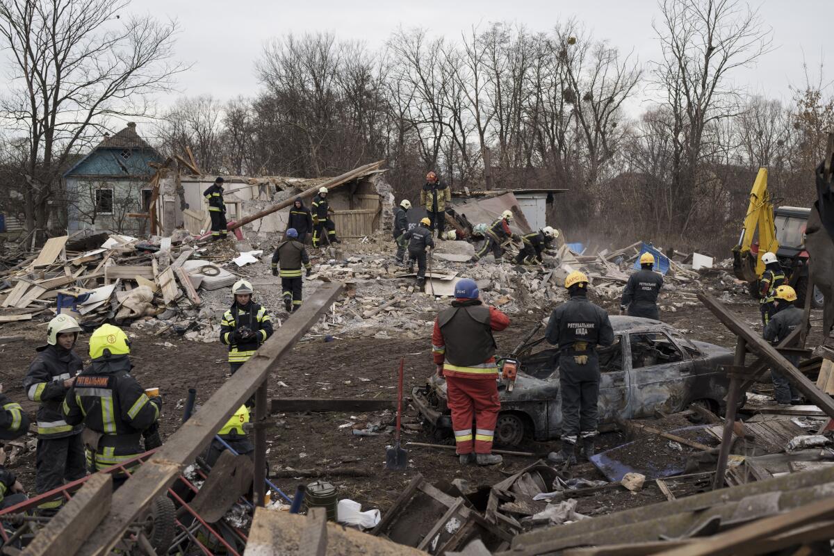 Emergency workers remove debris of a house destroyed following a Russian missile strike in Kyiv.