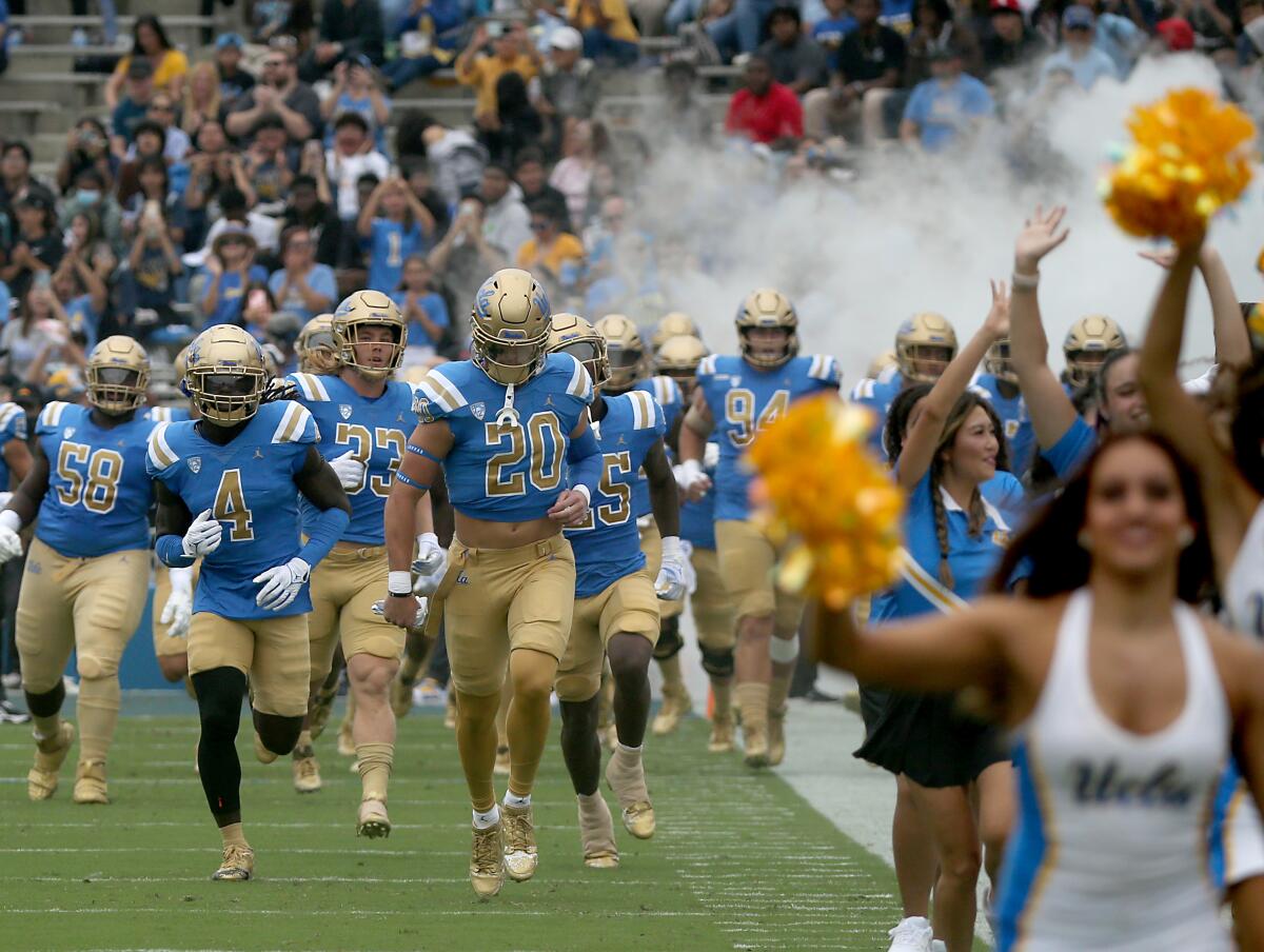 UCLA players take the field before the North Carolina Central game.
