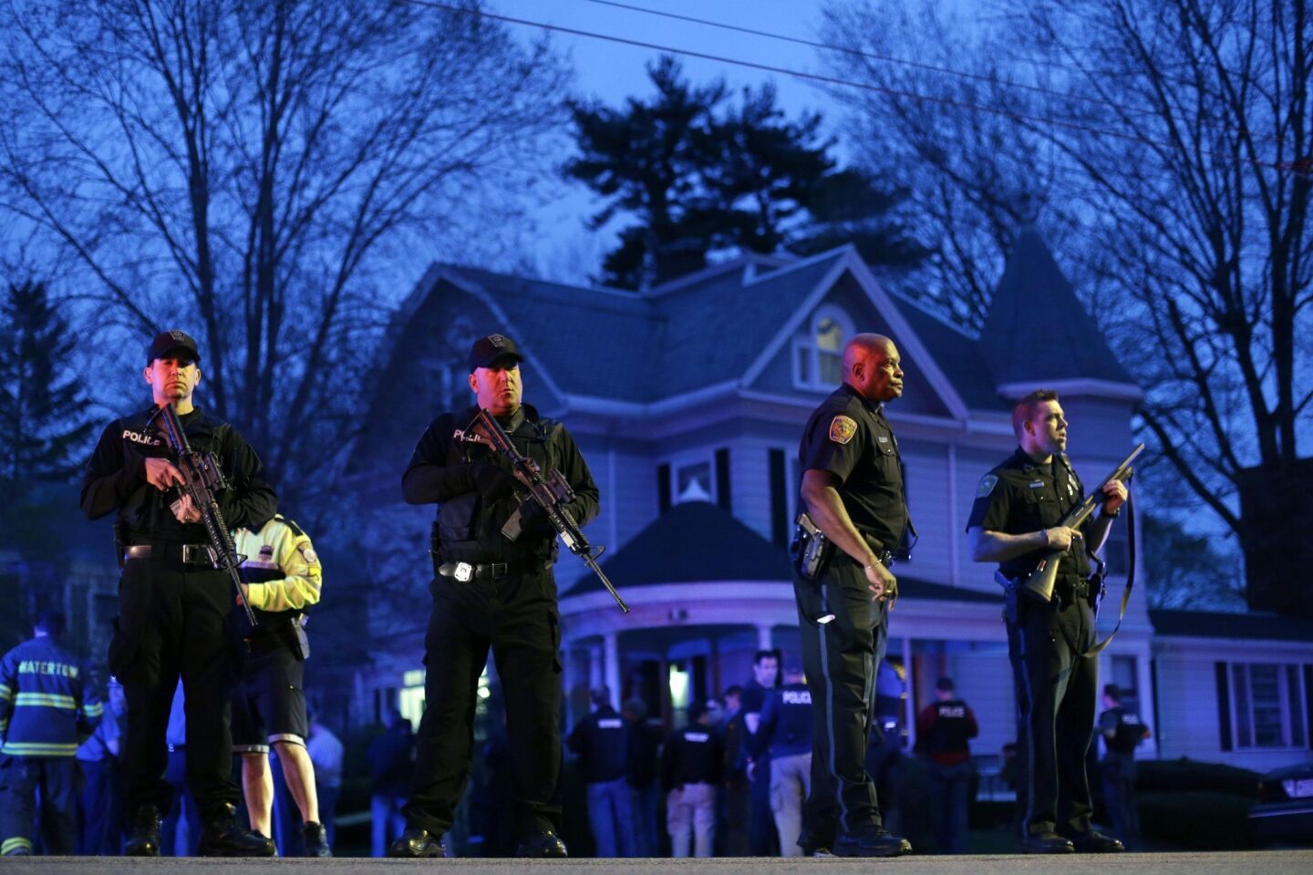 Police officers guard the entrance to Franklin Street in Watertown, Mass., where the surviving Boston Marathon bombing suspect was believed to be hiding. Dzhokhar Tsarnaev was taken into custody.