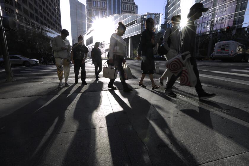 LOS ANGELES, CA - APRIL 10, 2023 - Pedestrians make their way through the streets of downtown Los Angeles on April 10, 2023. Genaro Molina / Los Angeles Times)