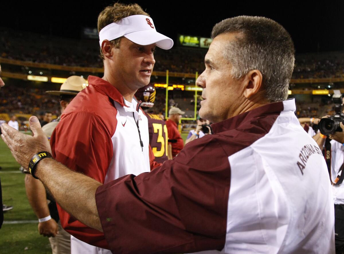 USC coach Lane Kiffin shakes hands with Arizona State coach Todd Graham after the Trojans lost to the Sun Devils.