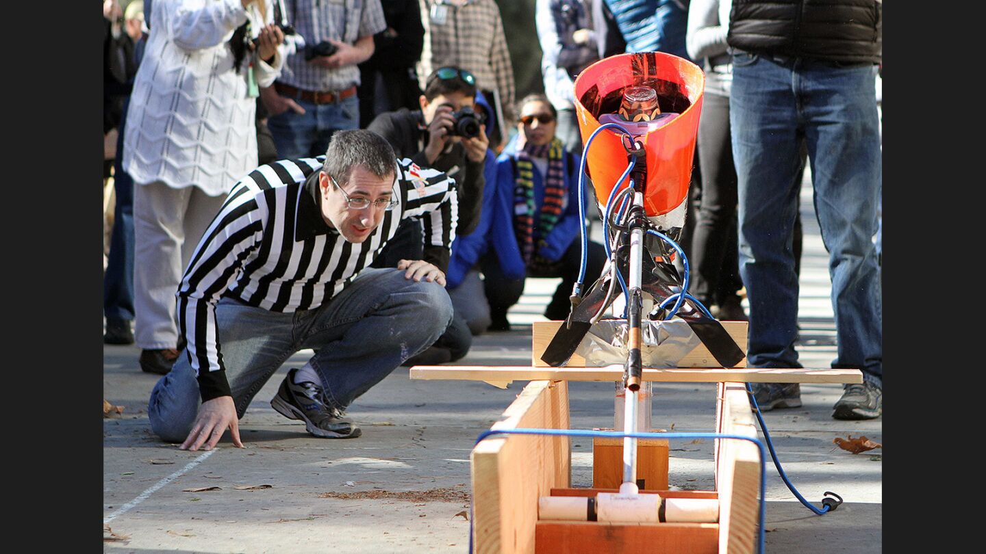 JPL's referee Chris Landry, Structural Engineering, closely watches water drop into a vessel at JPL's annual Invention Challenge on Friday, December 2, 2016. 28 teams, including a team from Tanzania, but mostly of local Southern California schools, competed. The challenge was to transfer a specific amount of water over a distance to a collection cup on the other side. Methods included catapults, conveyor belts, a lot of duct tape, and pvc.