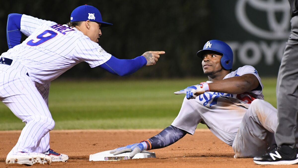 Yasiel Puig is tagged out while trying to stretch a single into a double as Cubs second baseman Javier Baez points to him in the ninth inning of NLCS Game 3 on Oct. 17.