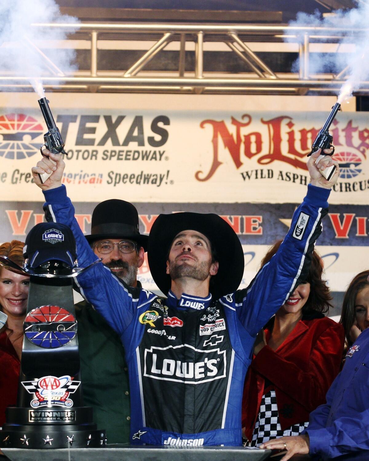 Jimmie Johnson fires blanks from a pair of revolvers as he celebrates his win in victory lane following the NASCAR Sprint Cup Series race at Texas Motor Speedway in Fort Worth in November.