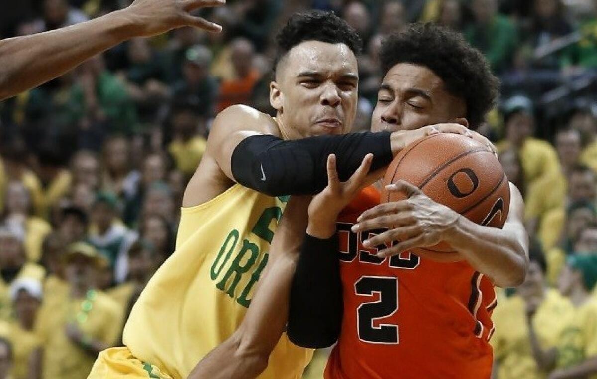 Oregon State's Stephen Thompson Jr., right, and Oregon's Dillon Brooks, left, compete for the ball during the first half of a game on Feb. 20.