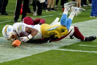 Los Angeles Chargers running back Austin Ekeler (30) scores a touchdown against the Arizona Cardinals during the second half of an NFL football game, Sunday, Nov. 27, 2022, in Glendale, Ariz. The Chargers defeated the Cardinals 25-24. (AP Photo/Ross D. Franklin)