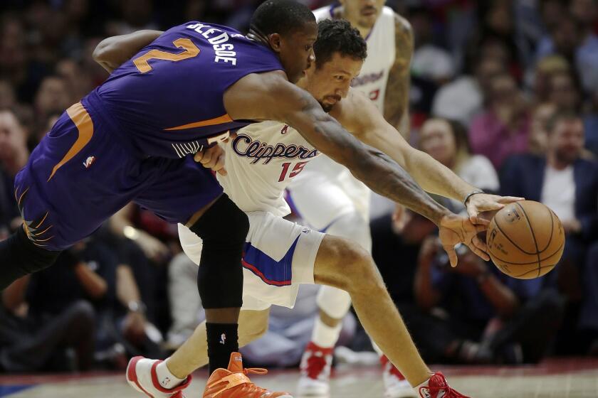 Clippers forward Hedo Turkoglu battles with Suns guard Eric Bledsoe for a loose ball during a preseason game on Wednesday at Staples Center.