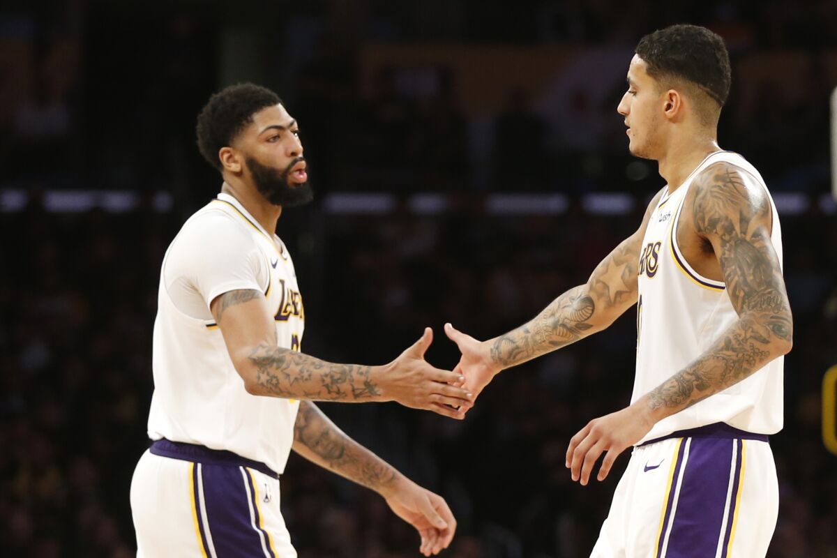 Kyle Kuzma and Anthony Davis high-five during the second half of a game against the Timberwolves on Dec. 8 at Staples Center.