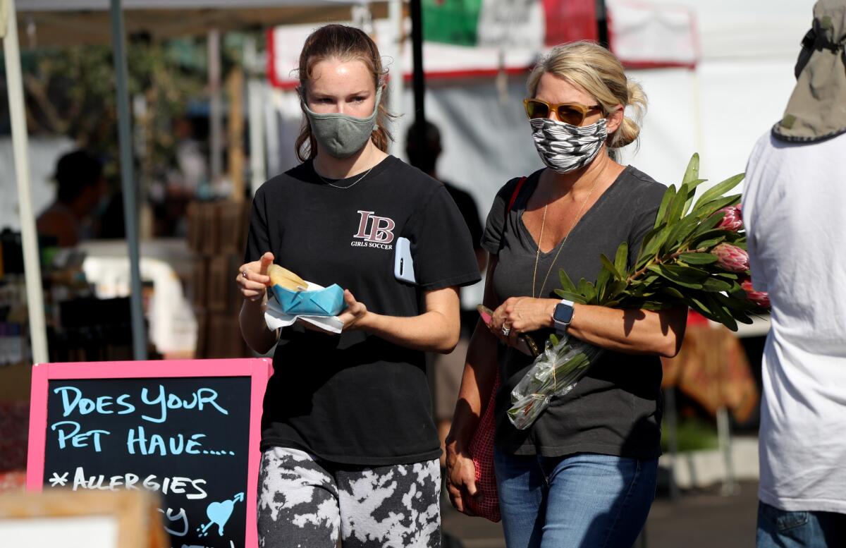 People shop at the  Laguna Beach farmers market, where on Sept. 18 an emergency preparedness event will take place.