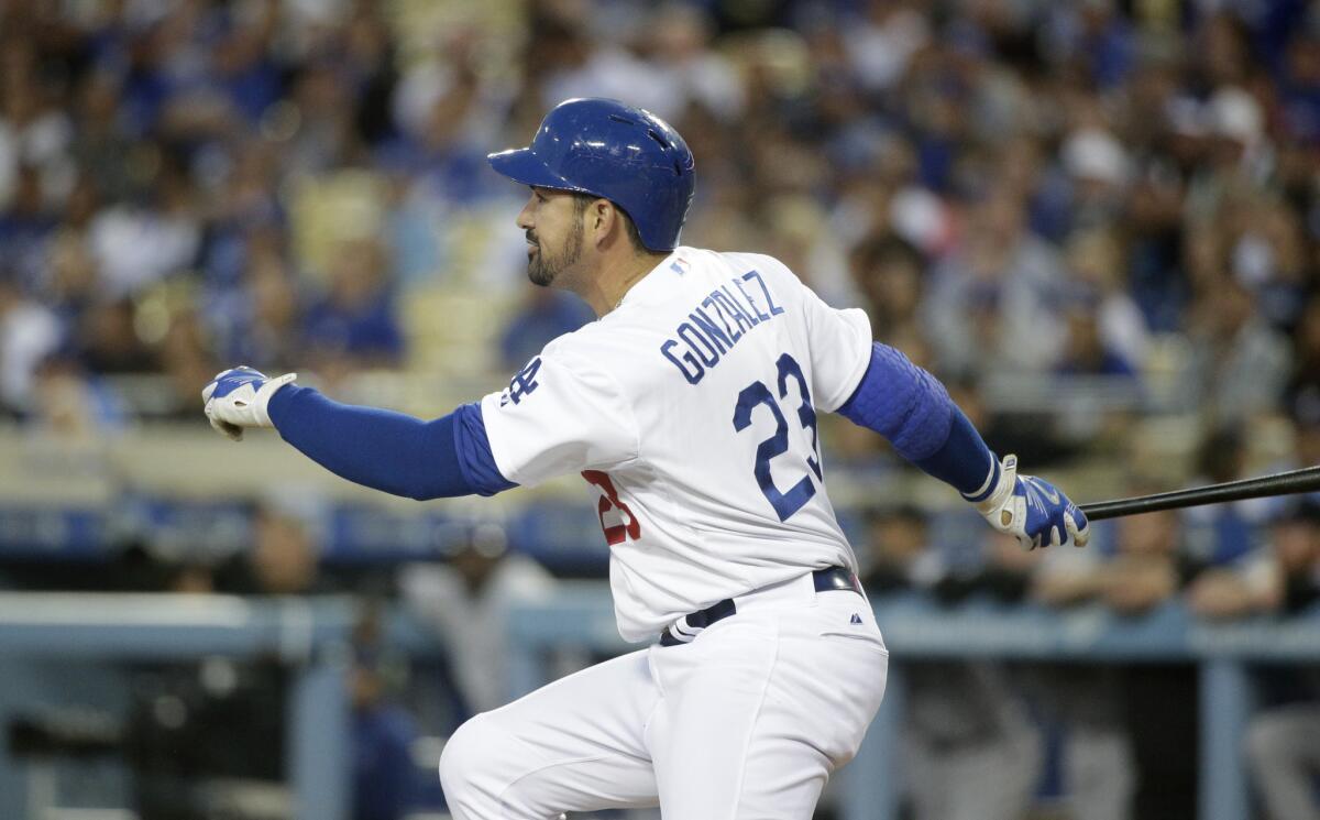 Dodgers first baseman Adrian Gonzalez breaks from the batter's box after connecting for a run-scoring double against the Rockies in the first inning Friday night.