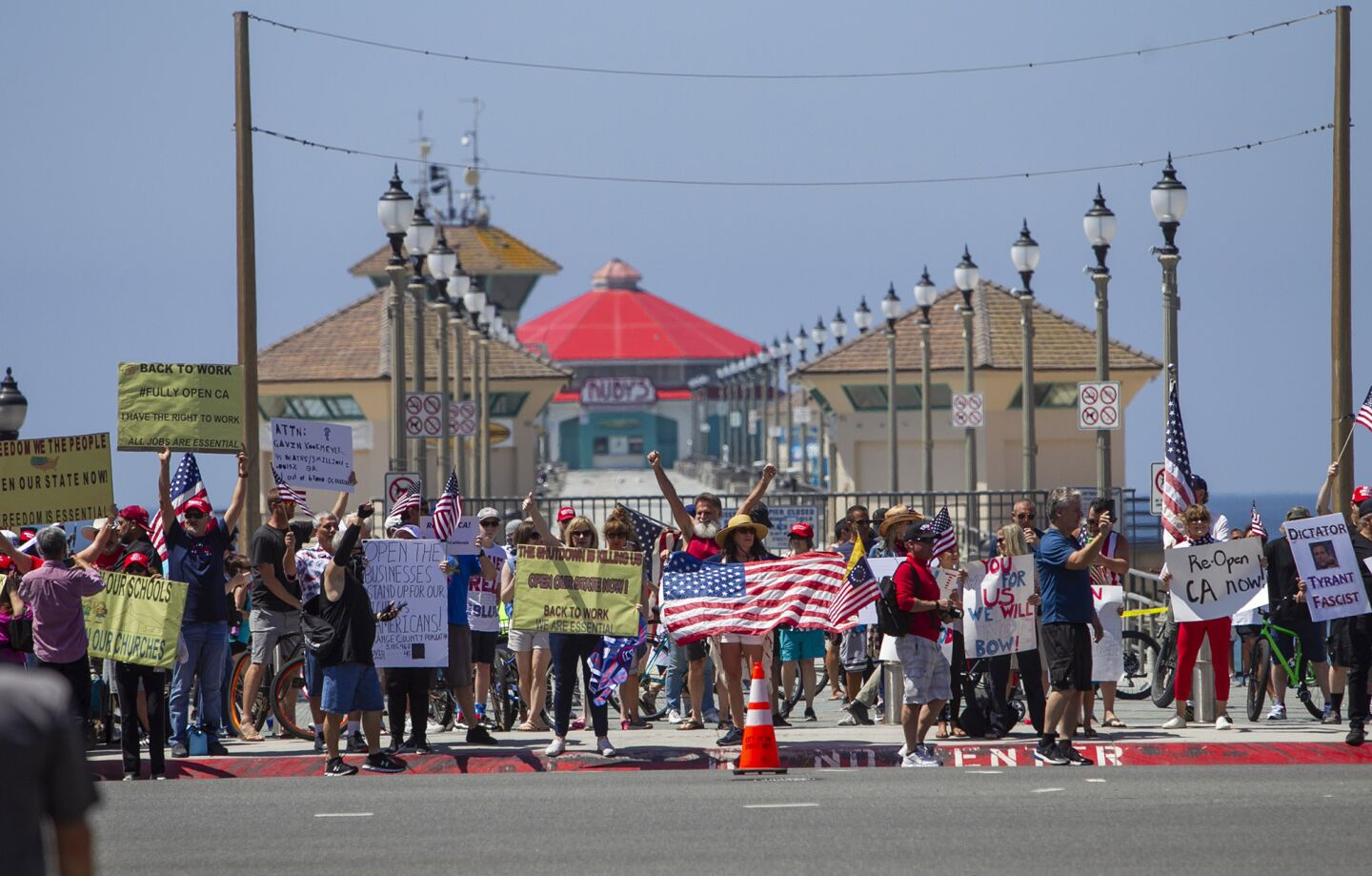 A large crowd gathers during a protest near the Huntington Beach Pier on Friday.