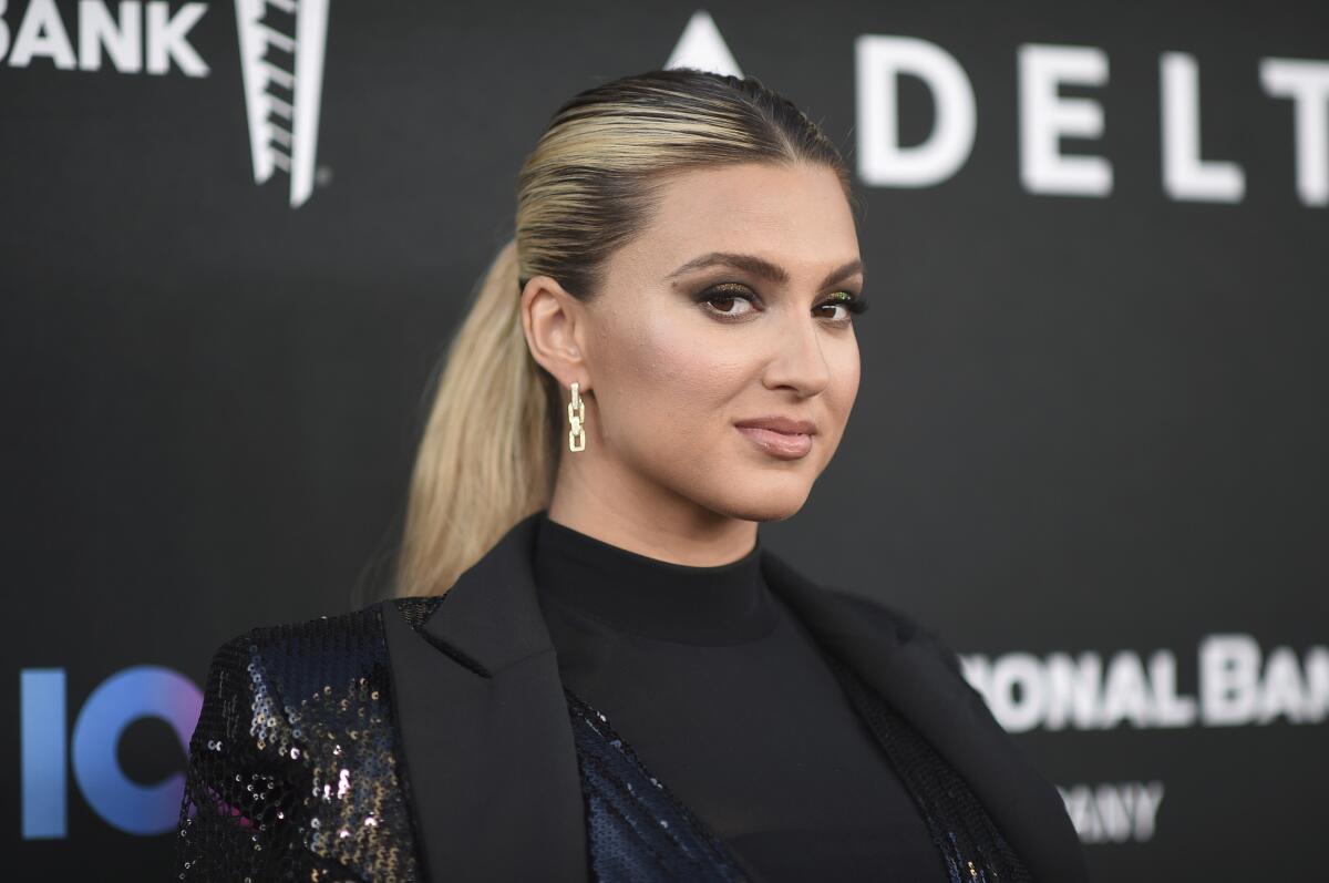Tori Kelly wears a black blazer as she poses for pictures at a red carpet event.