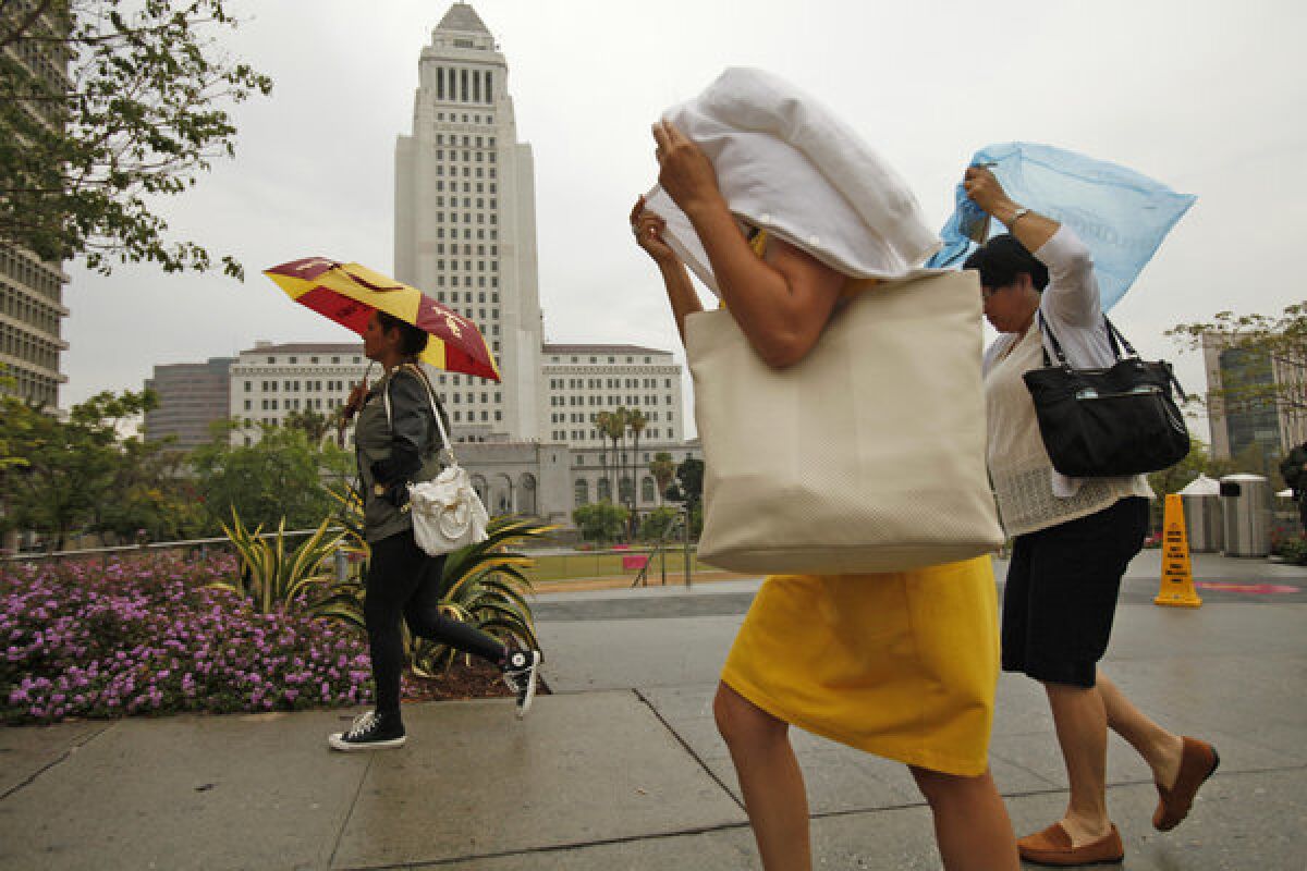 An unusual summer rain made for a wet walk in downtown Los Angeles on July 11.