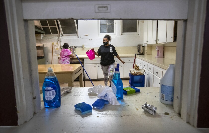 Celia Ortiz, left, and her granddaughter Jael Serrano-Altamirano help clean a kitchen at Heritage United Methodist Church.