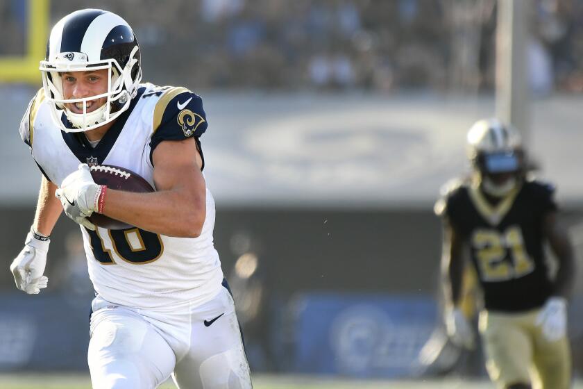 Rams receiver Cooper Kupp picks up big yards after a reception against the Saints in the 2nd quarter.