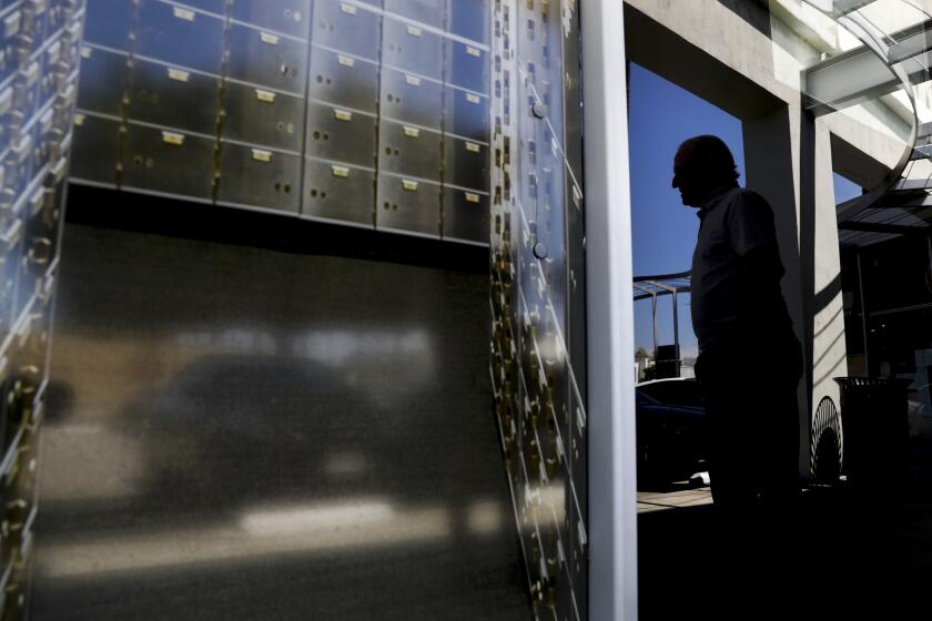 BEVERLY HILLS-CA-APRIL 7, 2021: William, who wishes to conceal his identity, is photographed at U.S. Private Vaults in Beverly Hills where he had stored cash and precious metals before federal agents descended on the Beverly Hills strip mall last month and seized the contents of hundreds of safe deposit boxes inside the store, on Wednesday, April 7, 2021. (Christina House / Los Angeles Times)