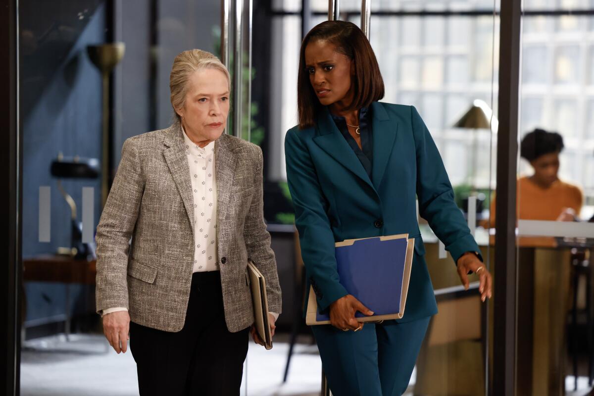 Two women walking in the corridor at a law firm.