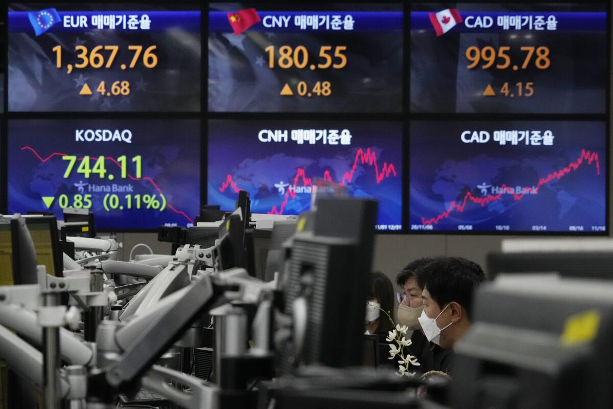 Currency traders watch monitors at KEB Hana Bank headquarters in Seoul.