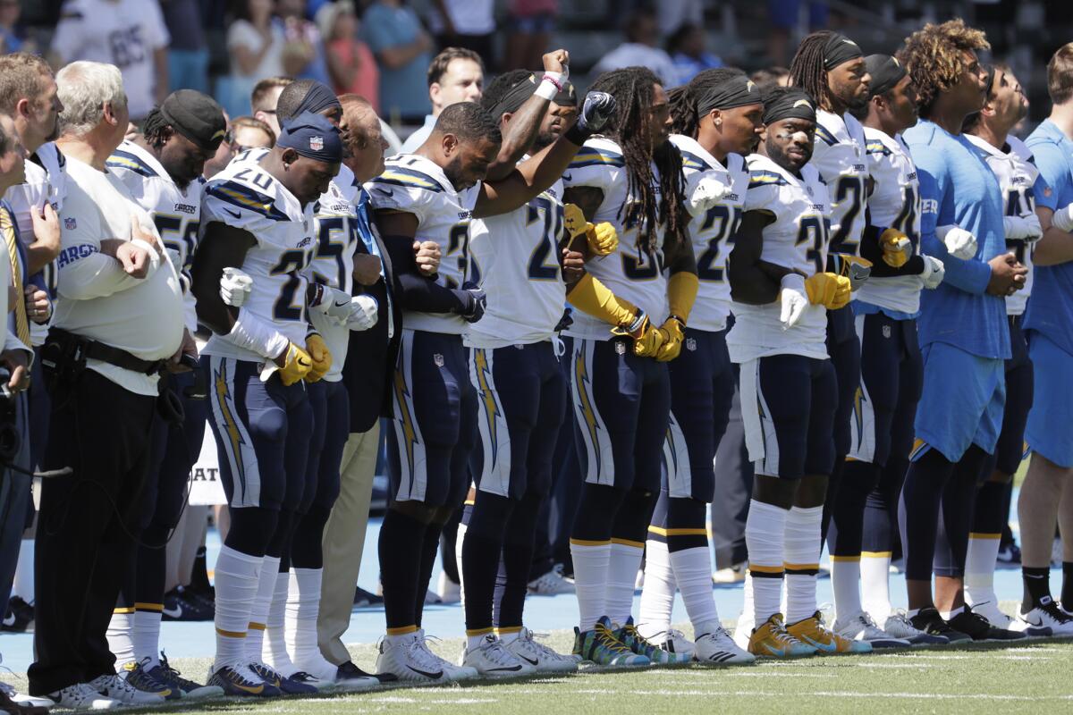 The San Diego Chargers link arms during the national anthem in a game against the Kansas City Chiefs at StubHub Center. (Robert Gauthier / Los Angeles Times)
