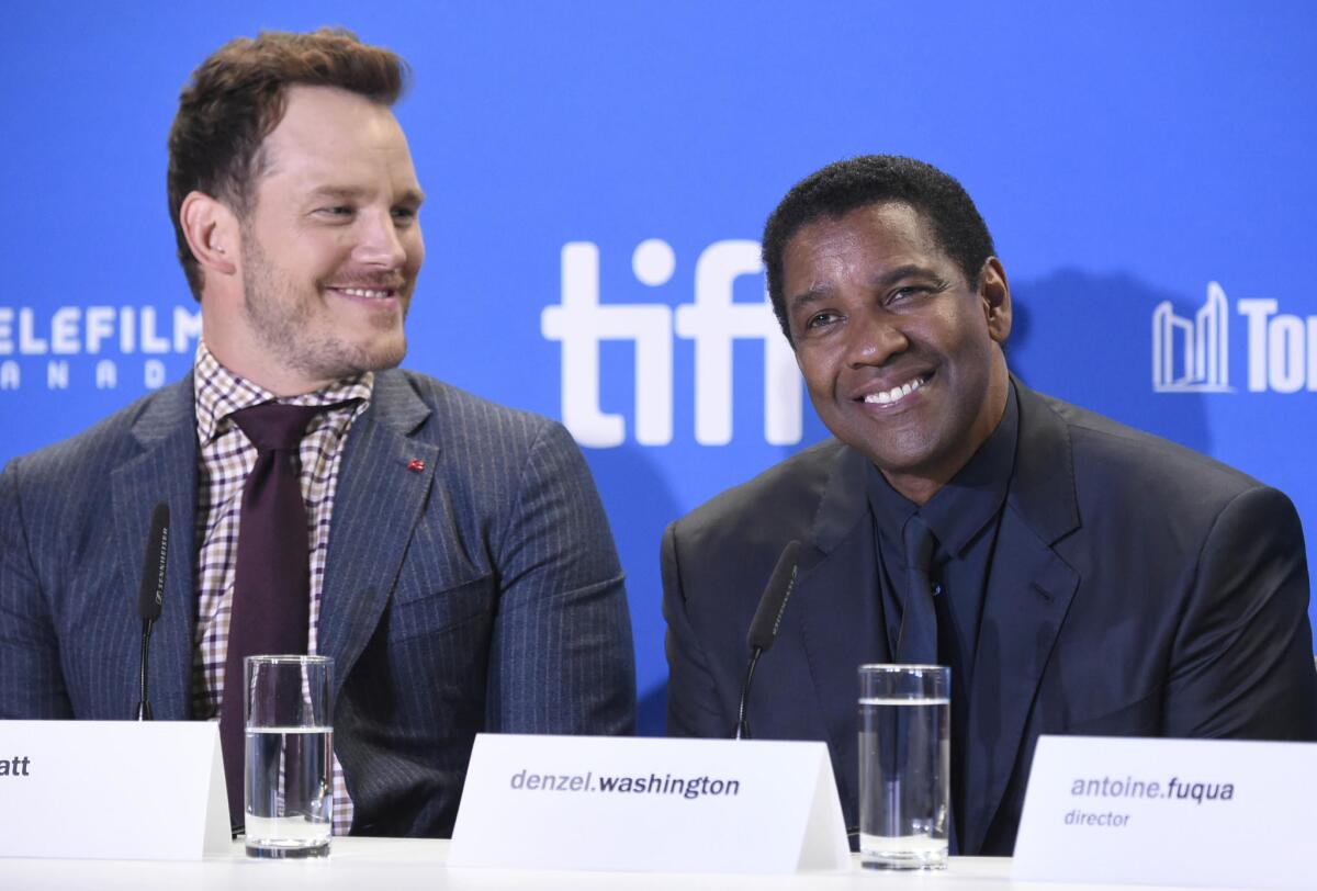 Chris Pratt, left, and Denzel Washinton participate in “The Magnificent Seven” press conference at the Toronto International Film Festival on Thursday.