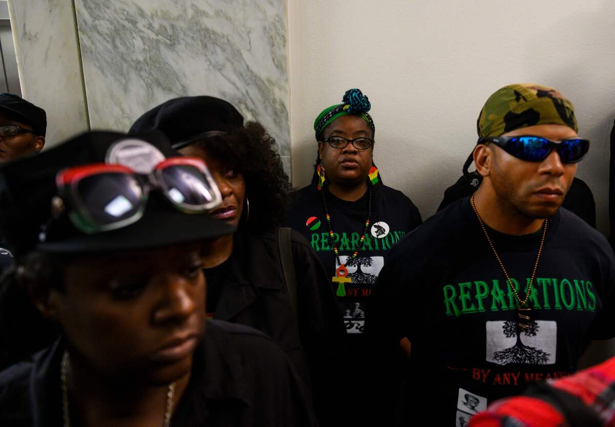 Activists line up June 19, 2019, for a House Judiciary Committee panel hearing on reparations for the descendants of slaves.