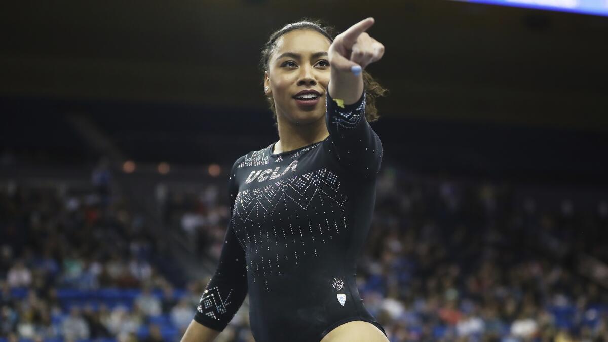 Margzetta Frazier points to the sideline during a gymnastics.