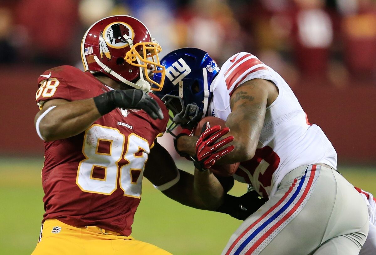Free safety Will Hill of the New York Giants strips the ball from wide receiver Pierre Garcon of the Washington Redskins.