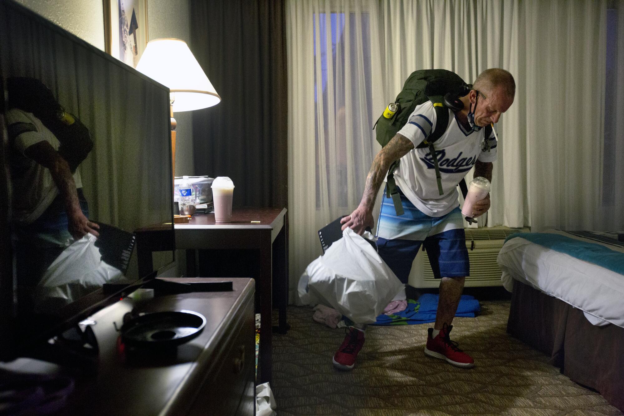 Kenneth Colato prepares to leave Lauren's hotel room in Van Nuys.