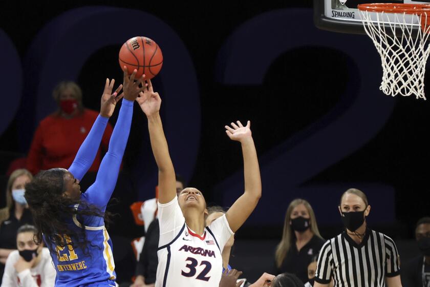 UCLA's Michaela Onyenwere goes up for a shot as Arizona's Lauren Ware defends March 5, 2021, in Las Vegas.
