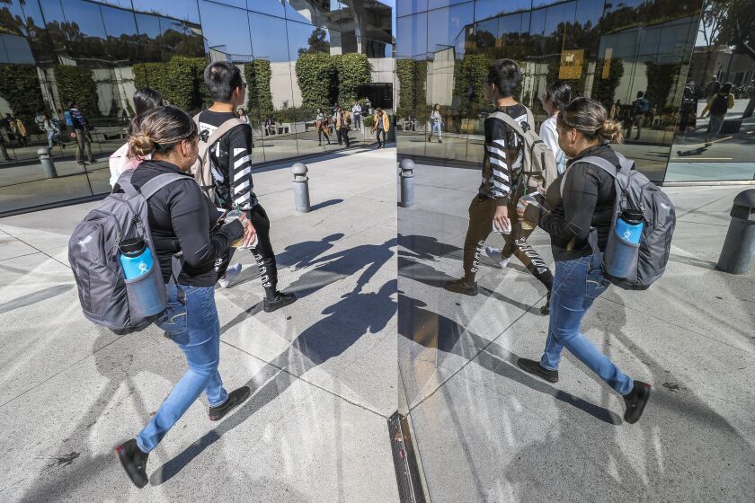 Students walk toward the entrance of the Geisel Library at the UCSD campus on Wednesday, November 6, 2019 in San Diego, California.