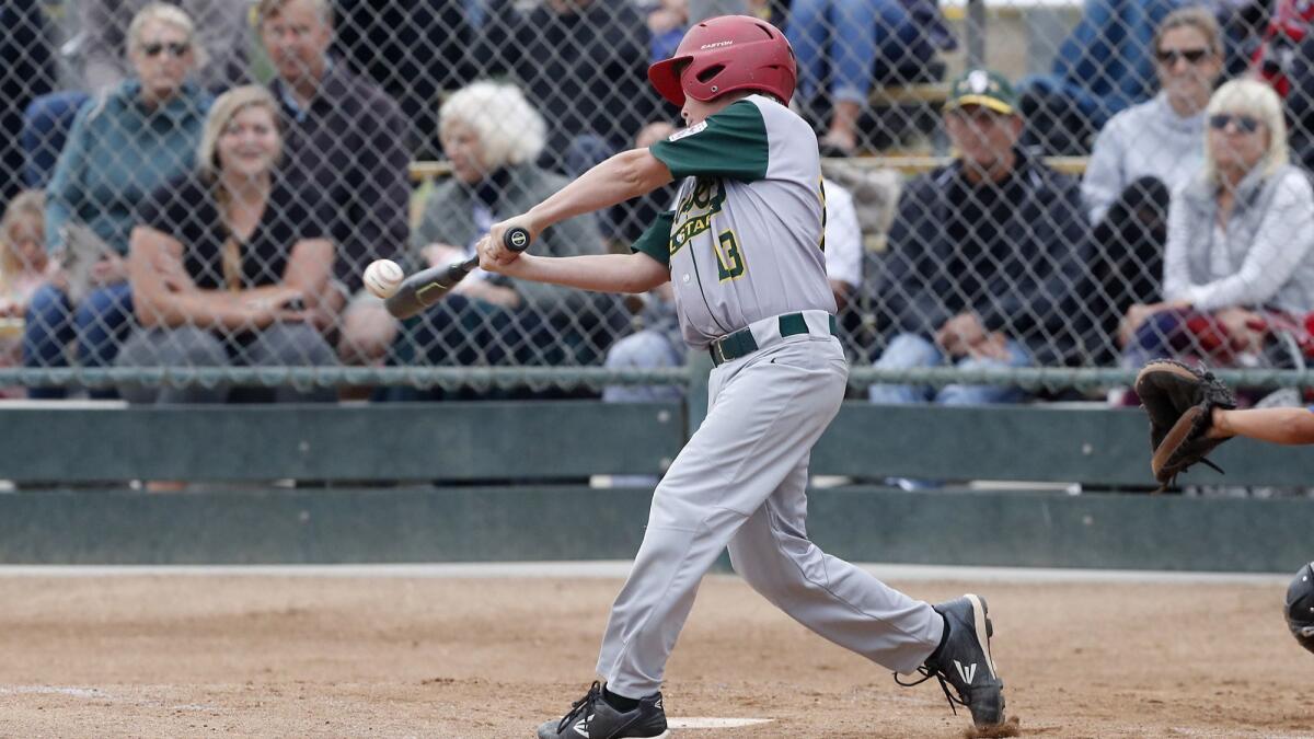 Seaview Little League's Joseph Rabay hits a two-run homer against Costa Mesa National in a Little League District 62 All-Stars Tournament game for 9- and 10-year-olds on Tuesday at Fountain Valley Sports Park.