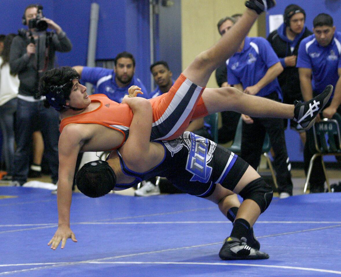 San Marino High's Michael Scott, throwing his opponent, won the 170 lb. match vs. South Pasadena High's J.C. Limon during match at San Marino High School in San Marino on Thursday, January 23, 2013.