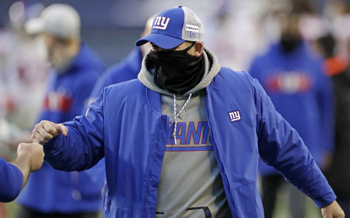 New York Giants head coach Joe Judge is greeted after an NFL football game against the Seattle Seahawks, Sunday, Dec. 6, 2020, in Seattle. The Giants won 17-12. (AP Photo/Larry Maurer)
