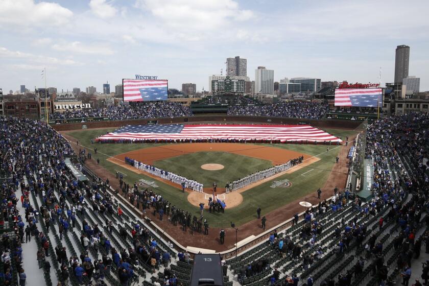 An American flag is unfurled in the outfield at Wrigley Field before the Chicago Cubs' home-opening baseball game against the Pittsburgh Pirates, Tuesday, April 10, 2018, in Chicago. (AP Photo/Jim Young)